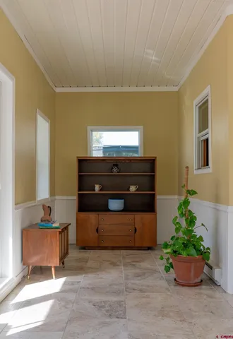a bedroom with a bed and a flat tv screen on the dresser