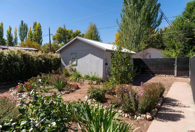 a view of a house with a yard and garden