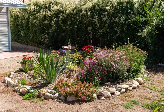 a view of a house with a yard and garden