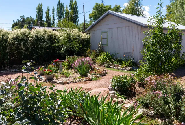 a view of a house with a yard and potted plants
