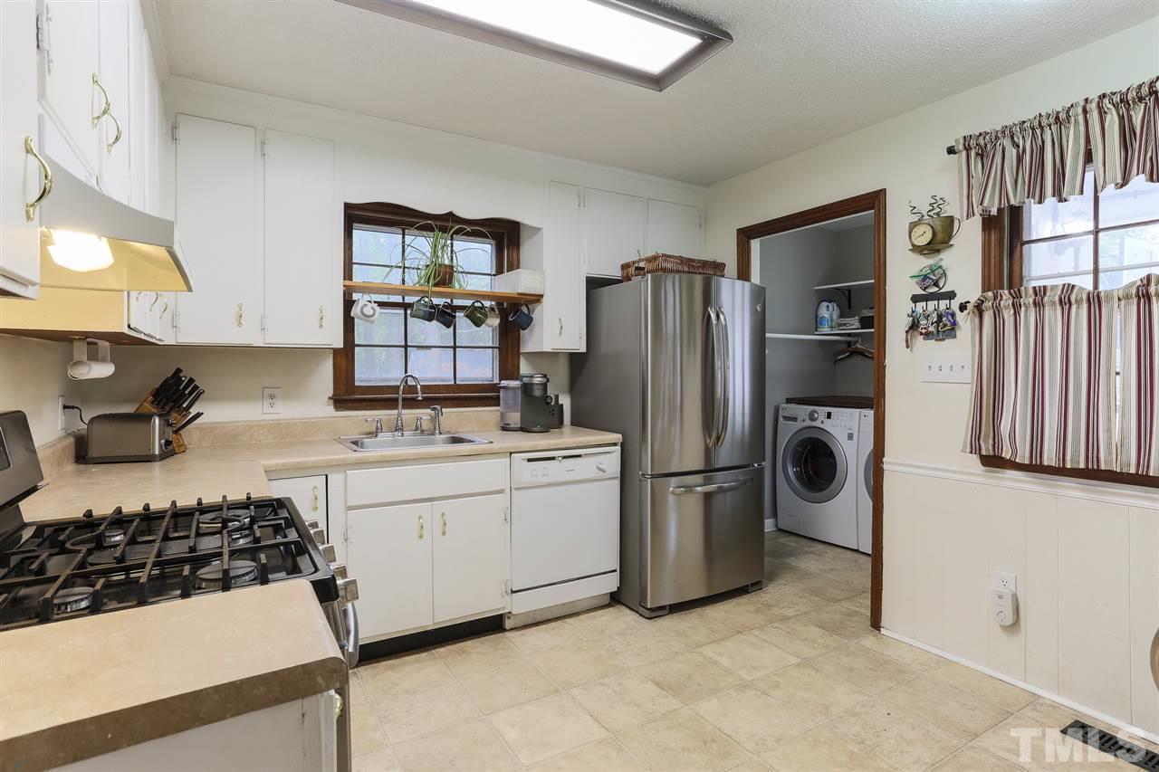 7613 Leesville Road Raleigh, NC 27613 - Photo 12 of 30 a kitchen with refrigerator and stove