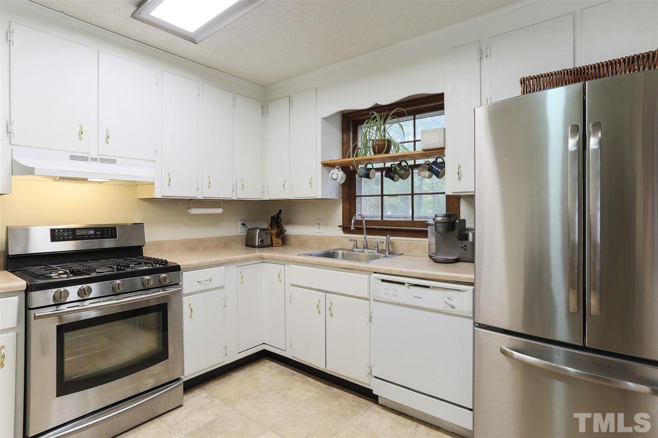 7613 Leesville Road Raleigh, NC 27613 - Photo 13 of 30 a kitchen with white cabinets and white appliances