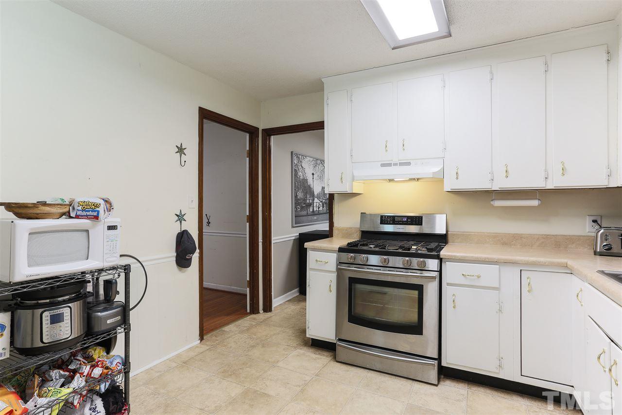 7613 Leesville Road Raleigh, NC 27613 - Photo 14 of 30 a kitchen with a stove and a refrigerator