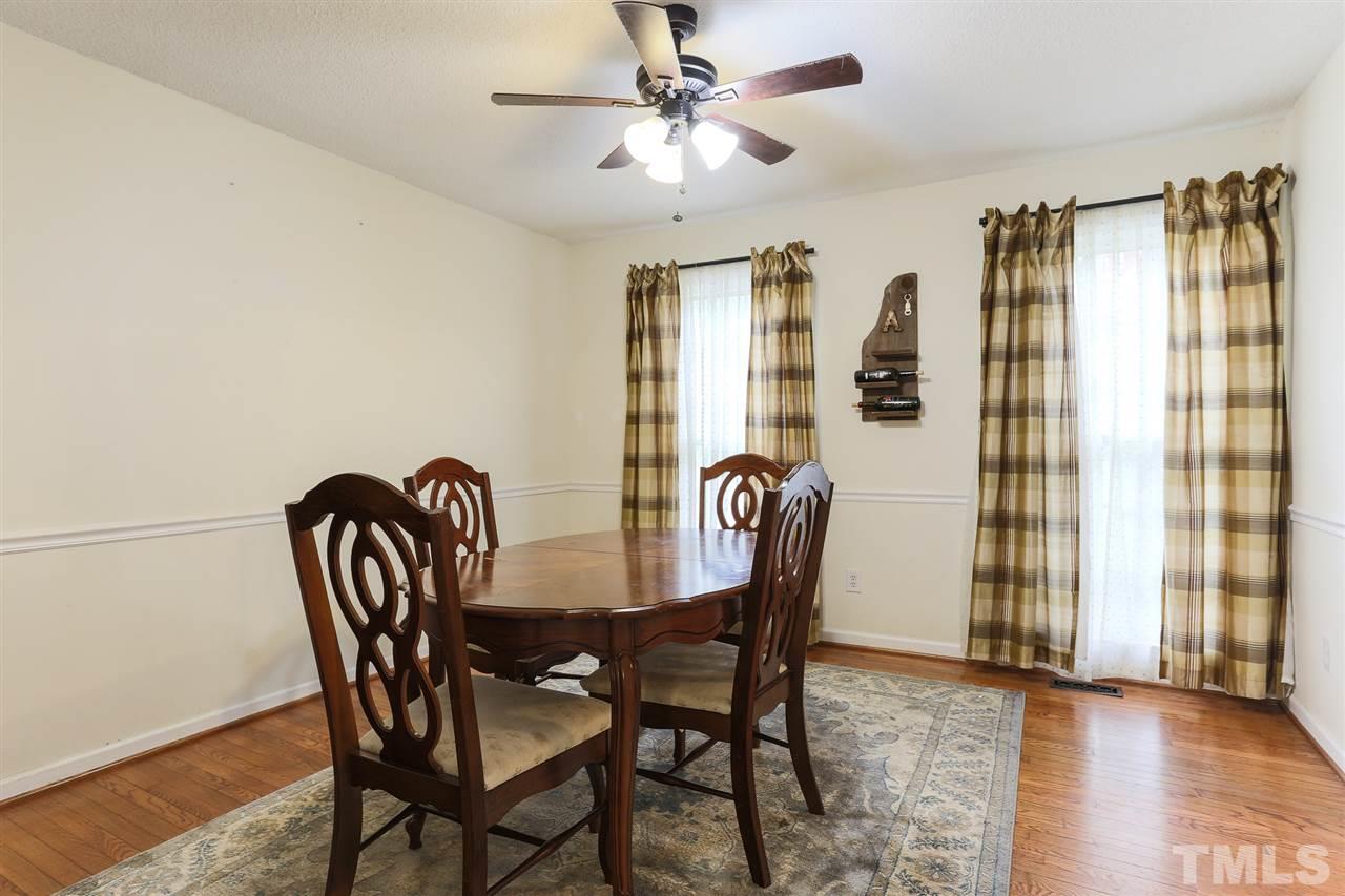 7613 Leesville Road Raleigh, NC 27613 - Photo 17 of 30 a view of a dining room with furniture and a chandelier