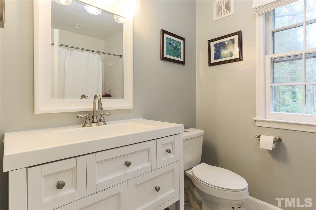 7613 Leesville Road Raleigh, NC 27613 - Photo 25 of 30 a bathroom with a toilet sink and mirror