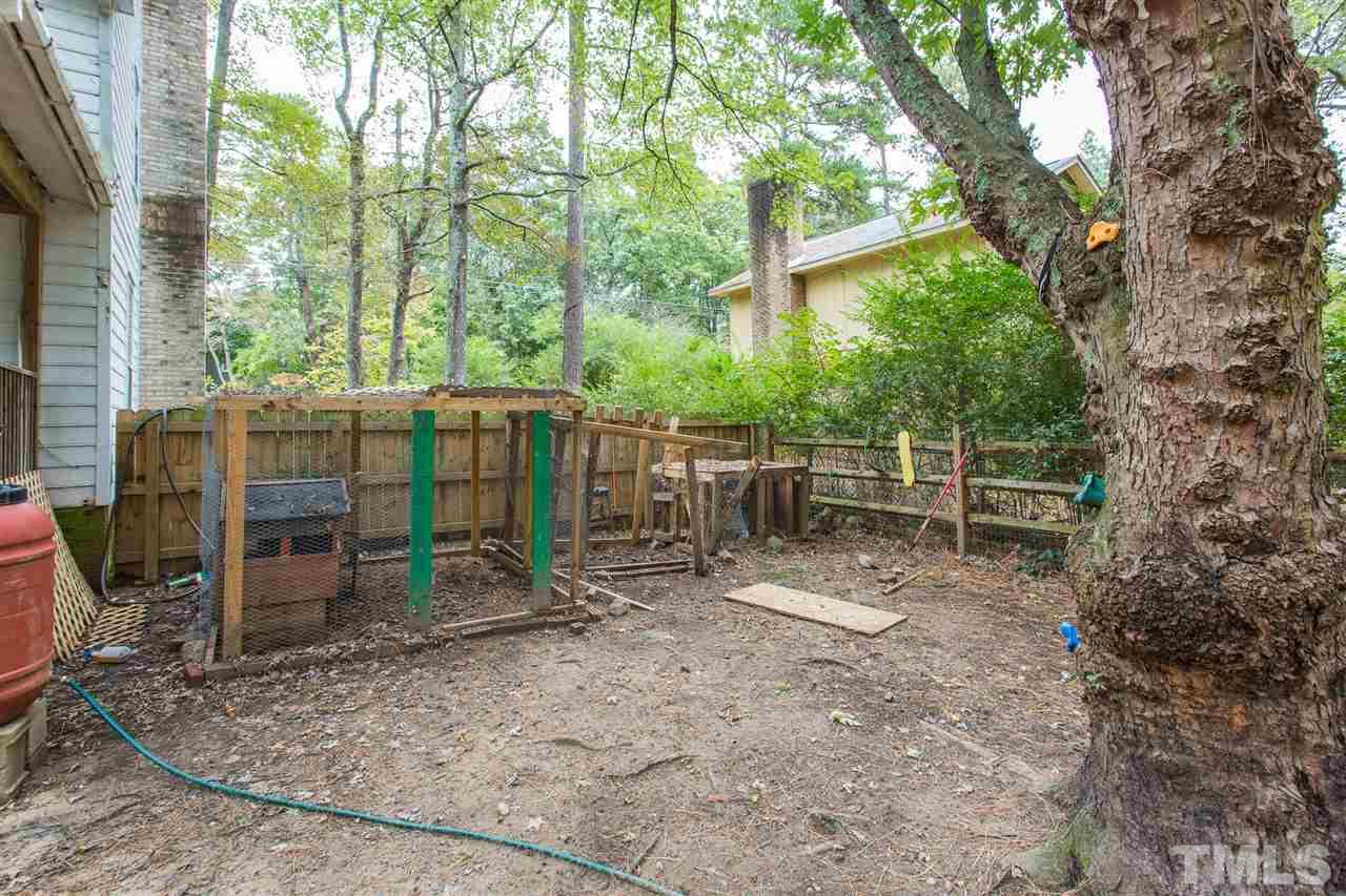 7613 Leesville Road Raleigh, NC 27613 - Photo 27 of 30 a view of backyard with wooden fence and large trees