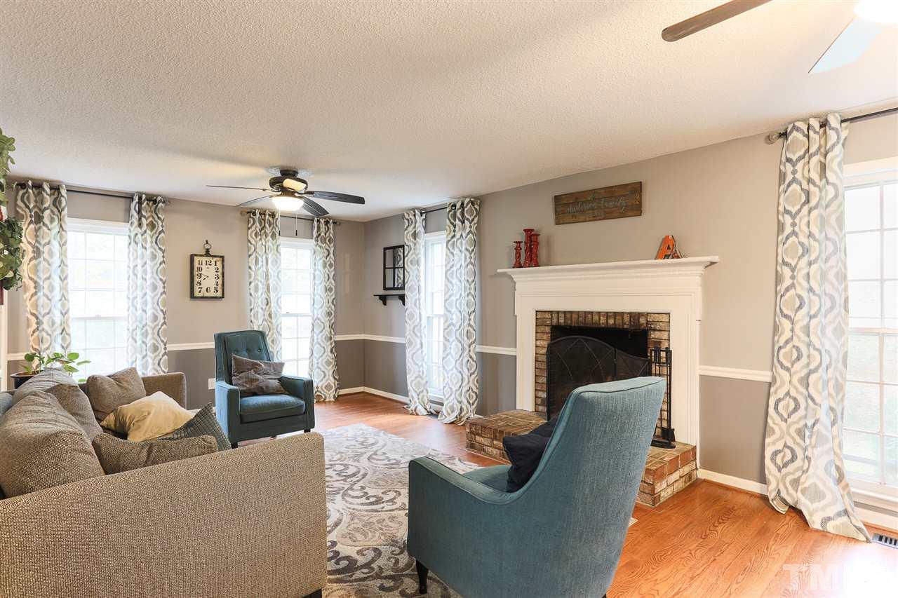 7613 Leesville Road Raleigh, NC 27613 - Photo 8 of 30 a living room with furniture and a fireplace
