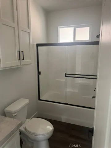 a white toilet sitting next to a window