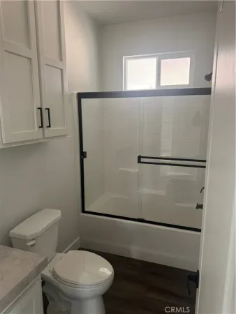 a white toilet sitting next to a window