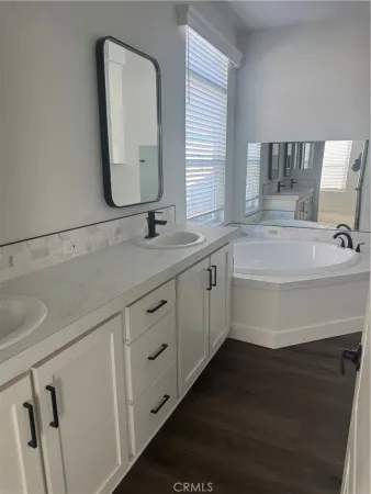 a bathroom with a double vanity sink and mirror