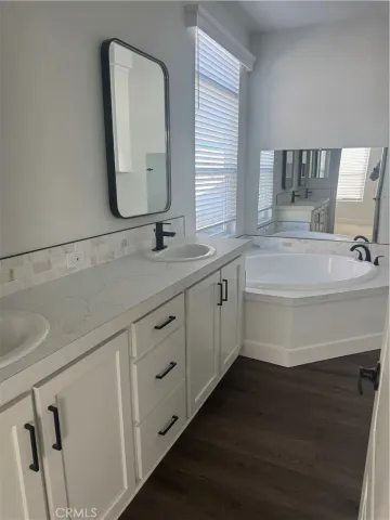 a bathroom with a double vanity sink and mirror
