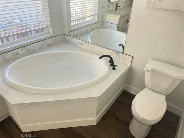 a white toilet sitting next to a bathroom sink