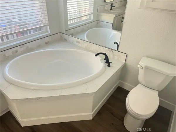 a white toilet sitting next to a bathroom sink