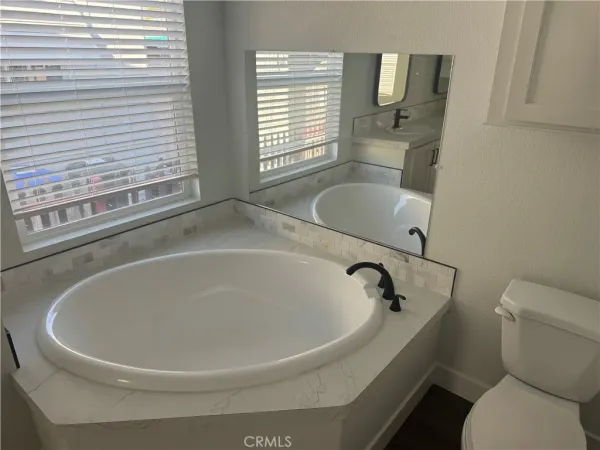 a white bath tub sitting next to a toilet