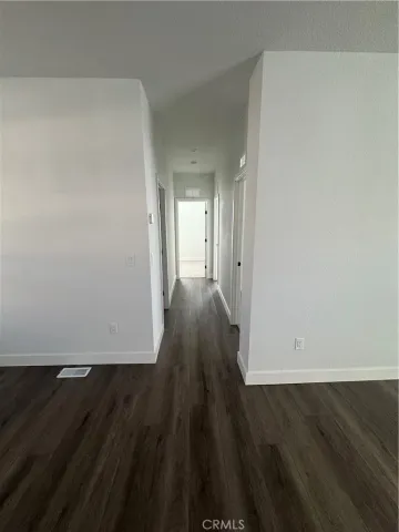 wooden floor in a hall with an empty room