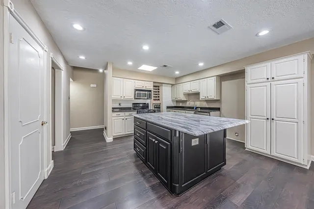 a kitchen with a stove and a refrigerator