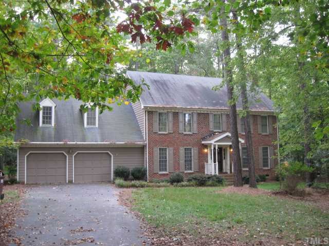 11001 Coachmans Way Raleigh, NC 27614 - Photo 1 of 8 a front view of a house with a garden