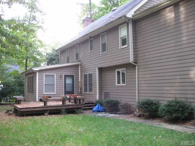 11001 Coachmans Way Raleigh, NC 27614 - Photo 2 of 8 a backyard of a house with yard table and chairs