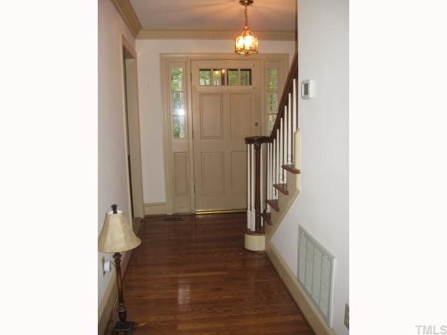 11001 Coachmans Way Raleigh, NC 27614 - Photo 3 of 8 a view of a hallway with wooden floor and staircase