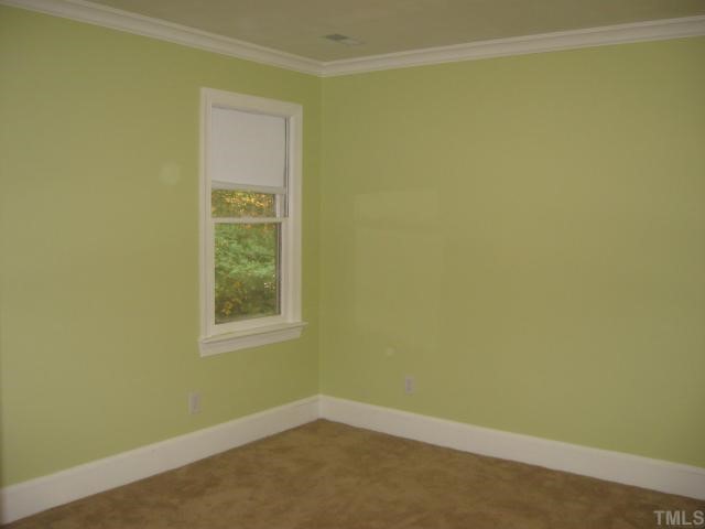 11001 Coachmans Way Raleigh, NC 27614 - Photo 5 of 8 an empty room with a window and a chair