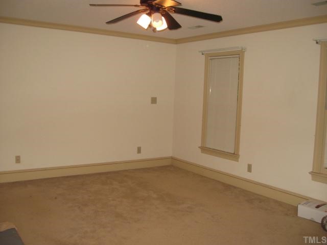 11001 Coachmans Way Raleigh, NC 27614 - Photo 6 of 8 an empty room with a chandelier fan