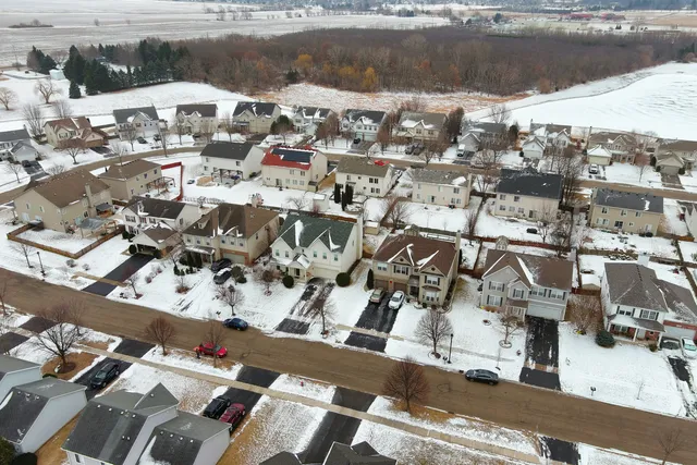 a hallway with wooden floor and a bookshelf
