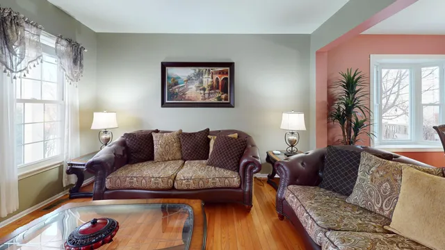 a bedroom with bed and a flat tv screen on dresser