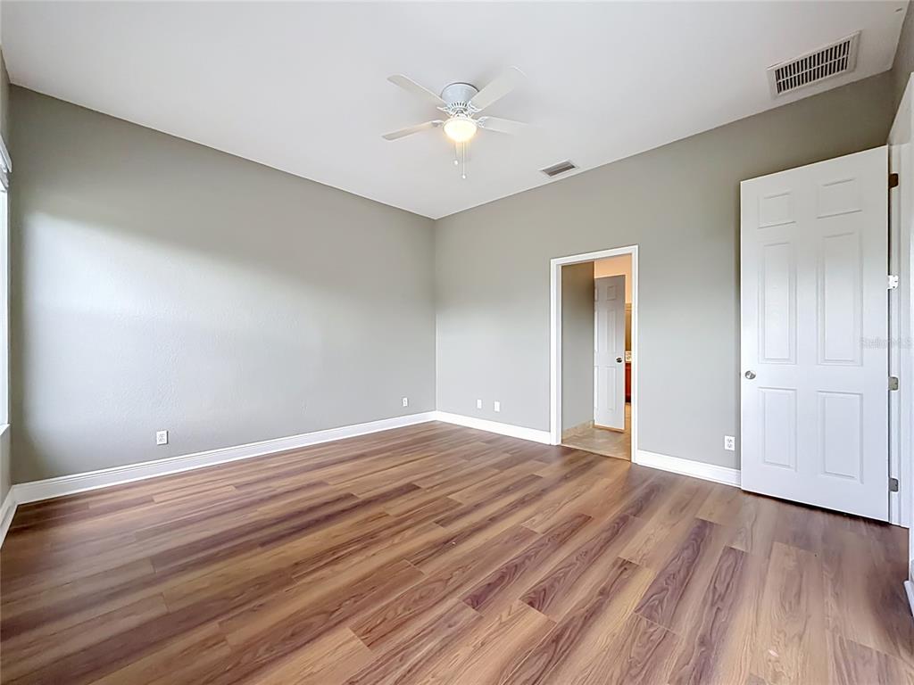 28549 Shirley Shores Road Tavares, FL 32778 - Photo 45 of 65 a view of an empty room with wooden floor