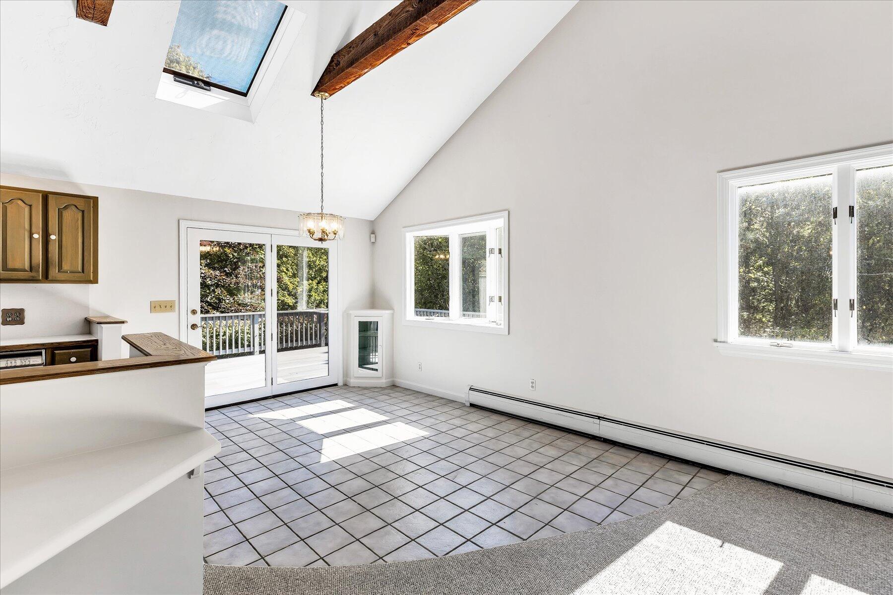 19 Mashnee Road Bourne, MA 02532 - Photo 12 of 46 a view of a kitchen with a sink and dishwasher next to a window