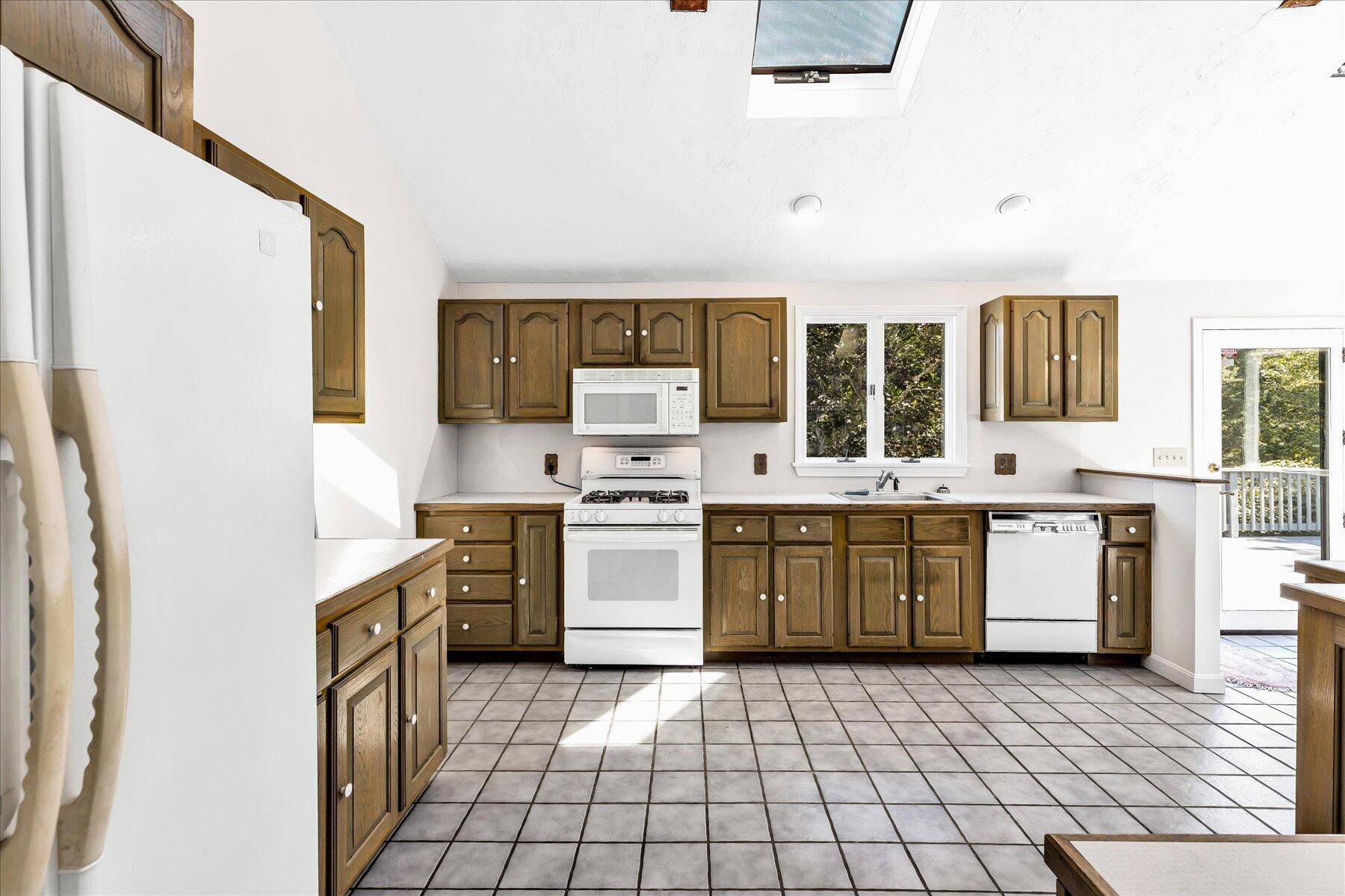 19 Mashnee Road Bourne, MA 02532 - Photo 16 of 46 a large white kitchen with a stove top oven