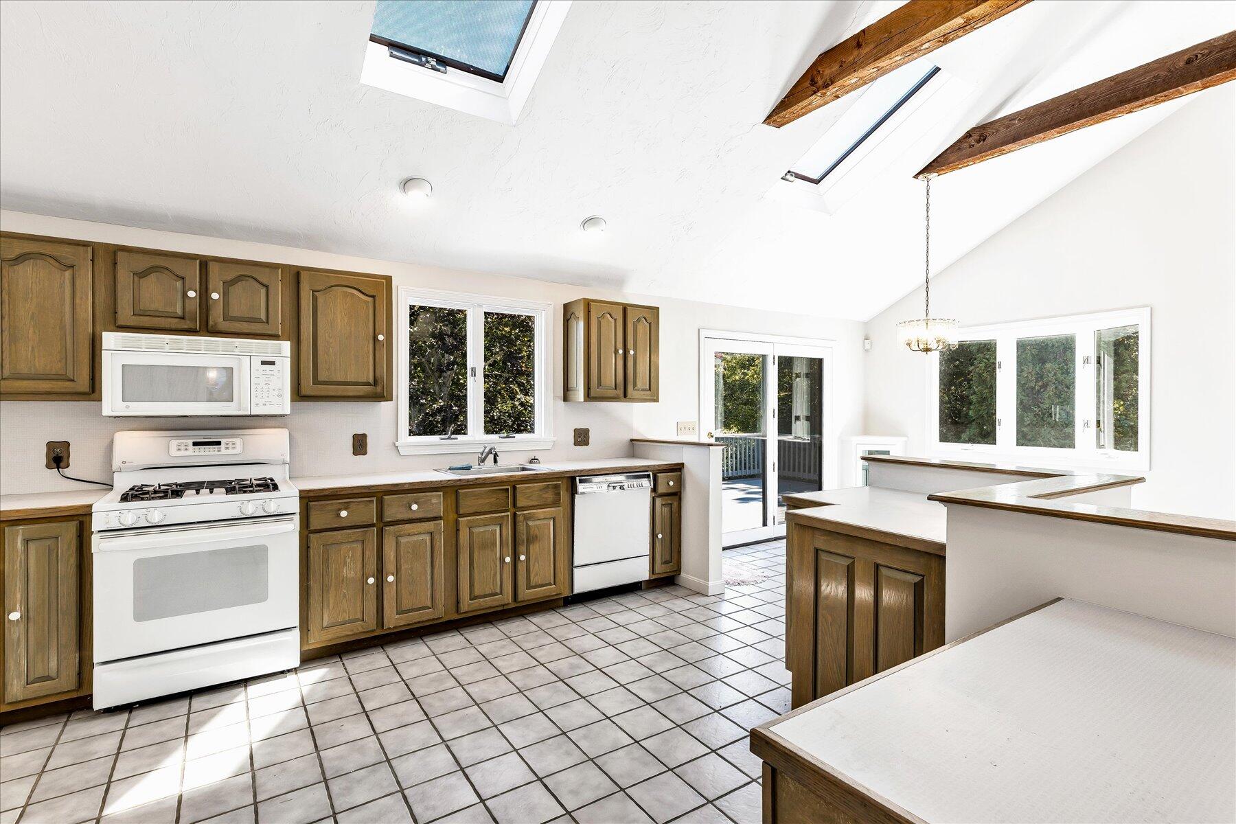 19 Mashnee Road Bourne, MA 02532 - Photo 17 of 46 a kitchen with a stove a sink and a refrigerator