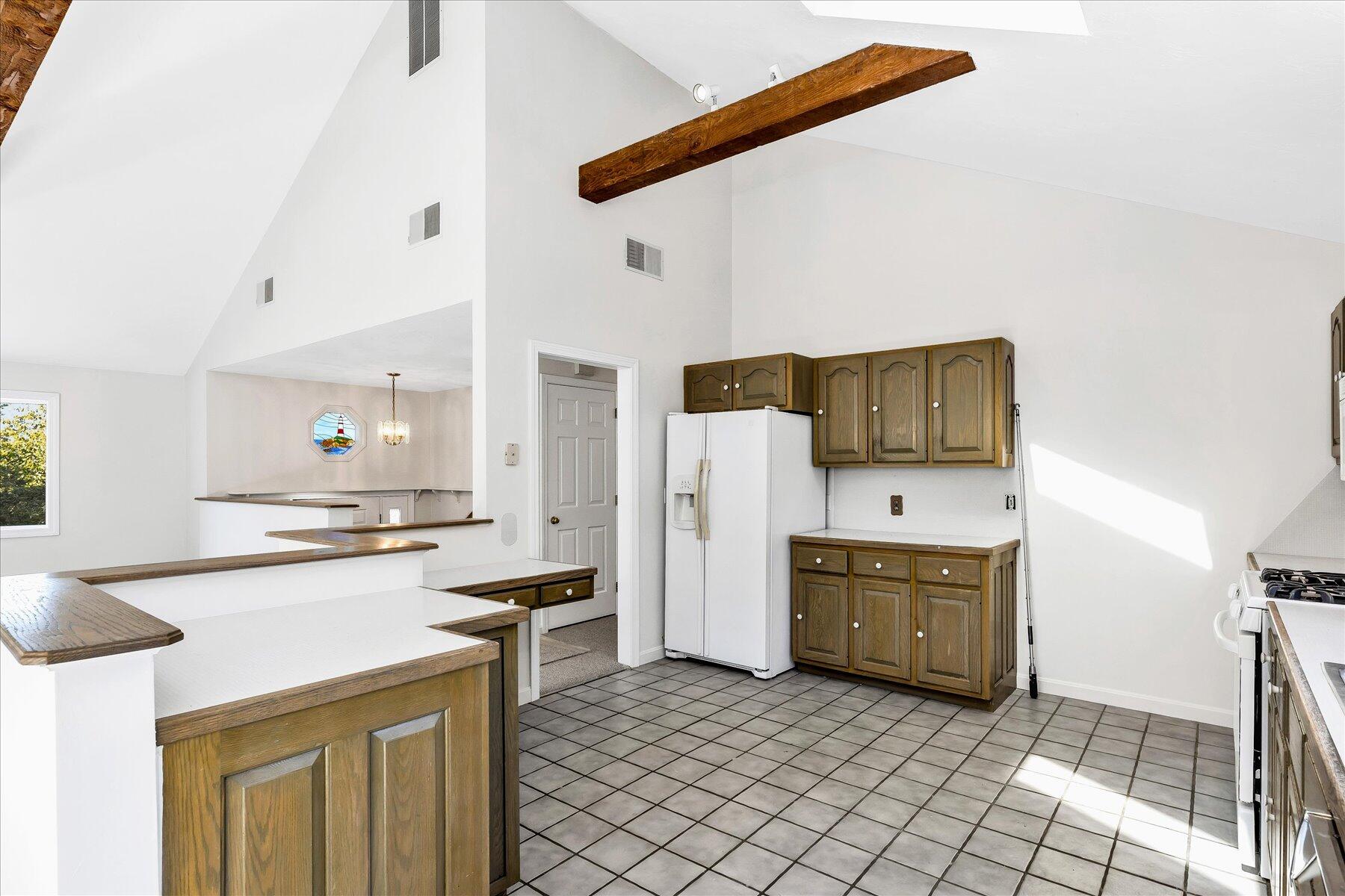 19 Mashnee Road Bourne, MA 02532 - Photo 18 of 46 a kitchen with stainless steel appliances a stove a refrigerator and cabinets