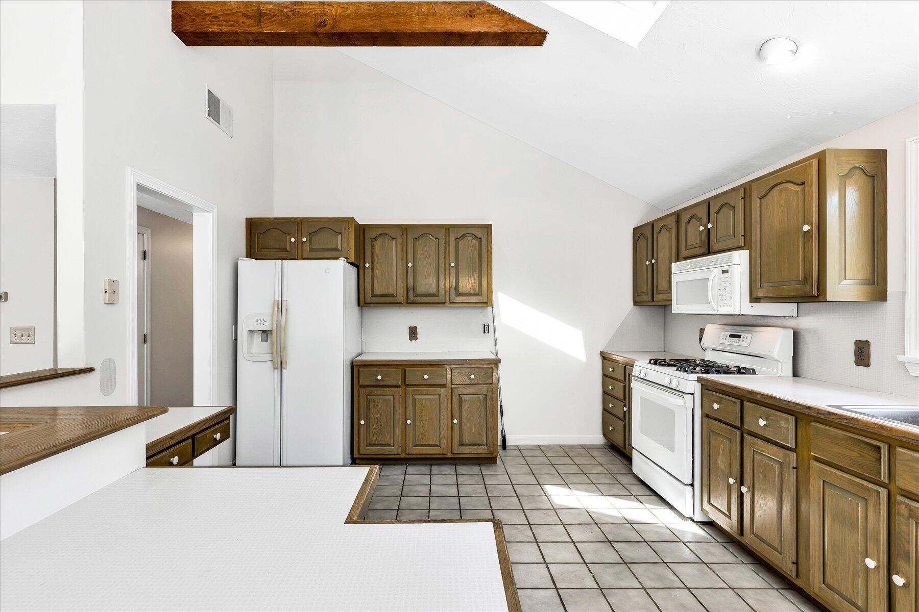 19 Mashnee Road Bourne, MA 02532 - Photo 19 of 46 a kitchen with stainless steel appliances a refrigerator sink and stove