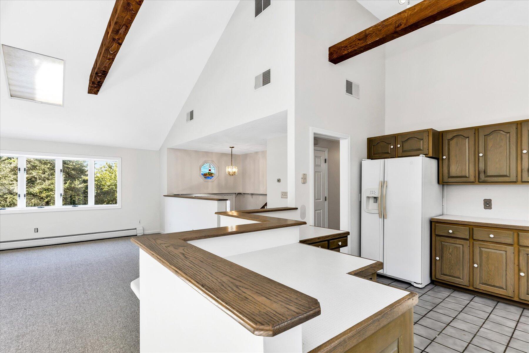 19 Mashnee Road Bourne, MA 02532 - Photo 20 of 46 a kitchen with a sink a stove and refrigerator