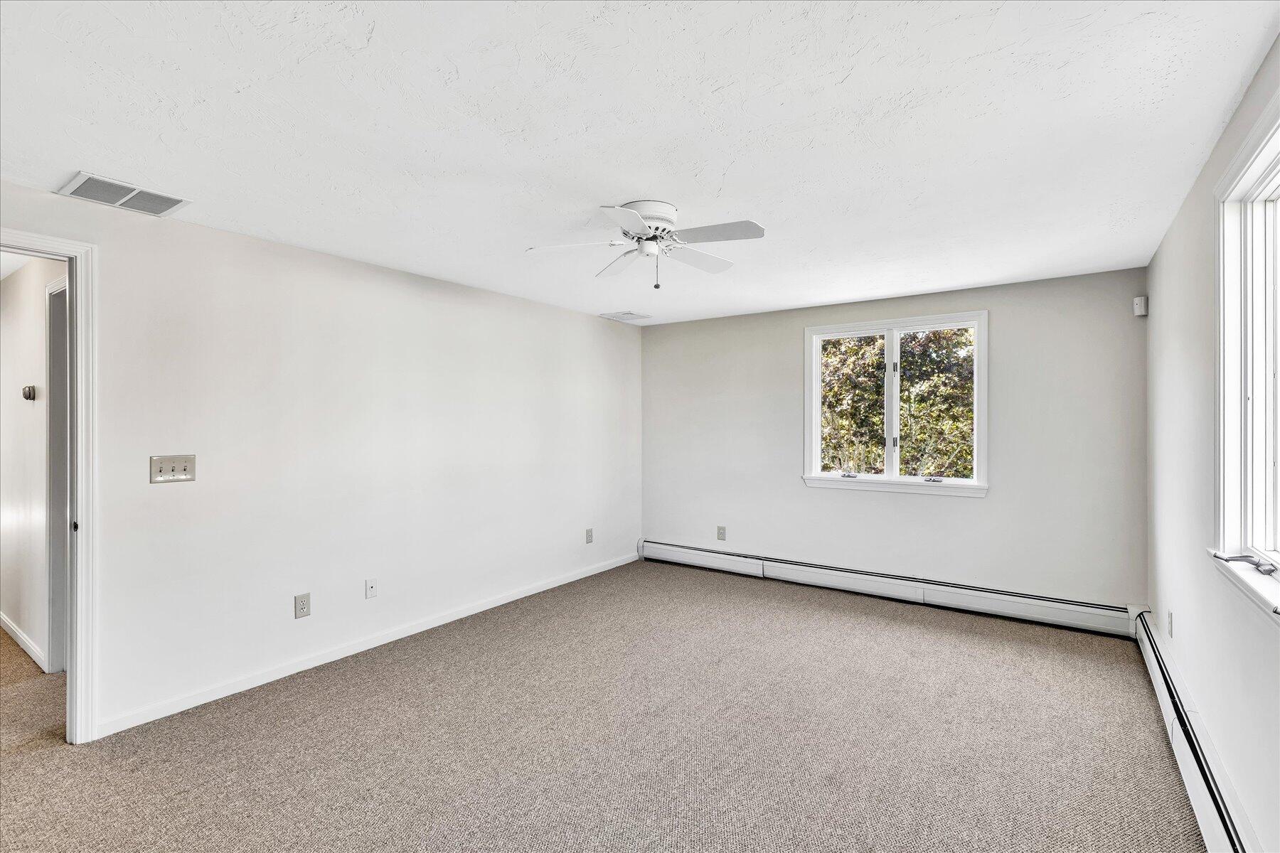 19 Mashnee Road Bourne, MA 02532 - Photo 27 of 46 an empty room with a window and a ceiling fan