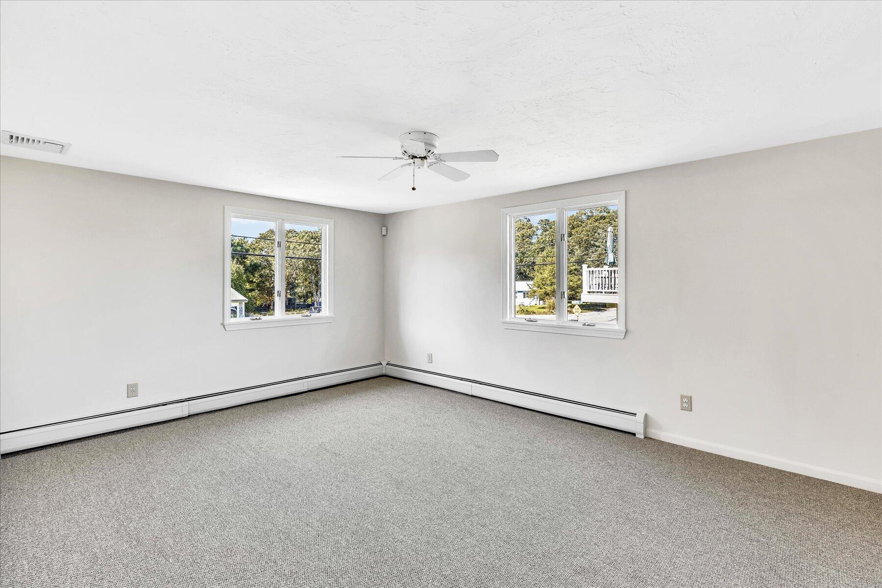 19 Mashnee Road Bourne, MA 02532 - Photo 28 of 46 an empty room with windows and ceiling fan