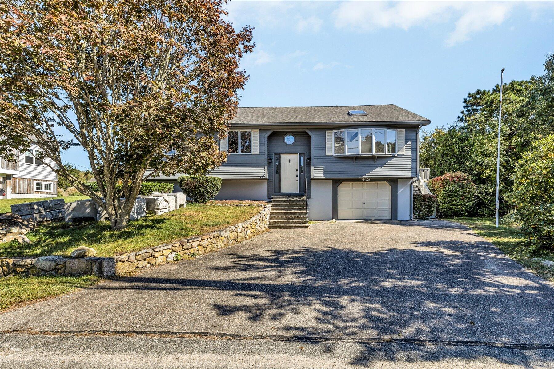 19 Mashnee Road Bourne, MA 02532 - Photo 3 of 46 a front view of a house with a yard