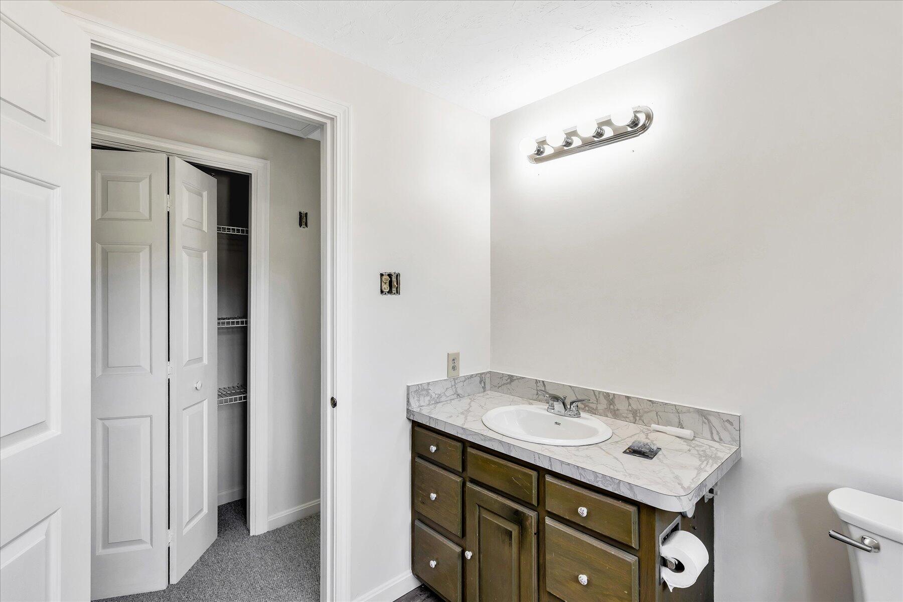 19 Mashnee Road Bourne, MA 02532 - Photo 32 of 46 a bathroom with a sink vanity and a mirror