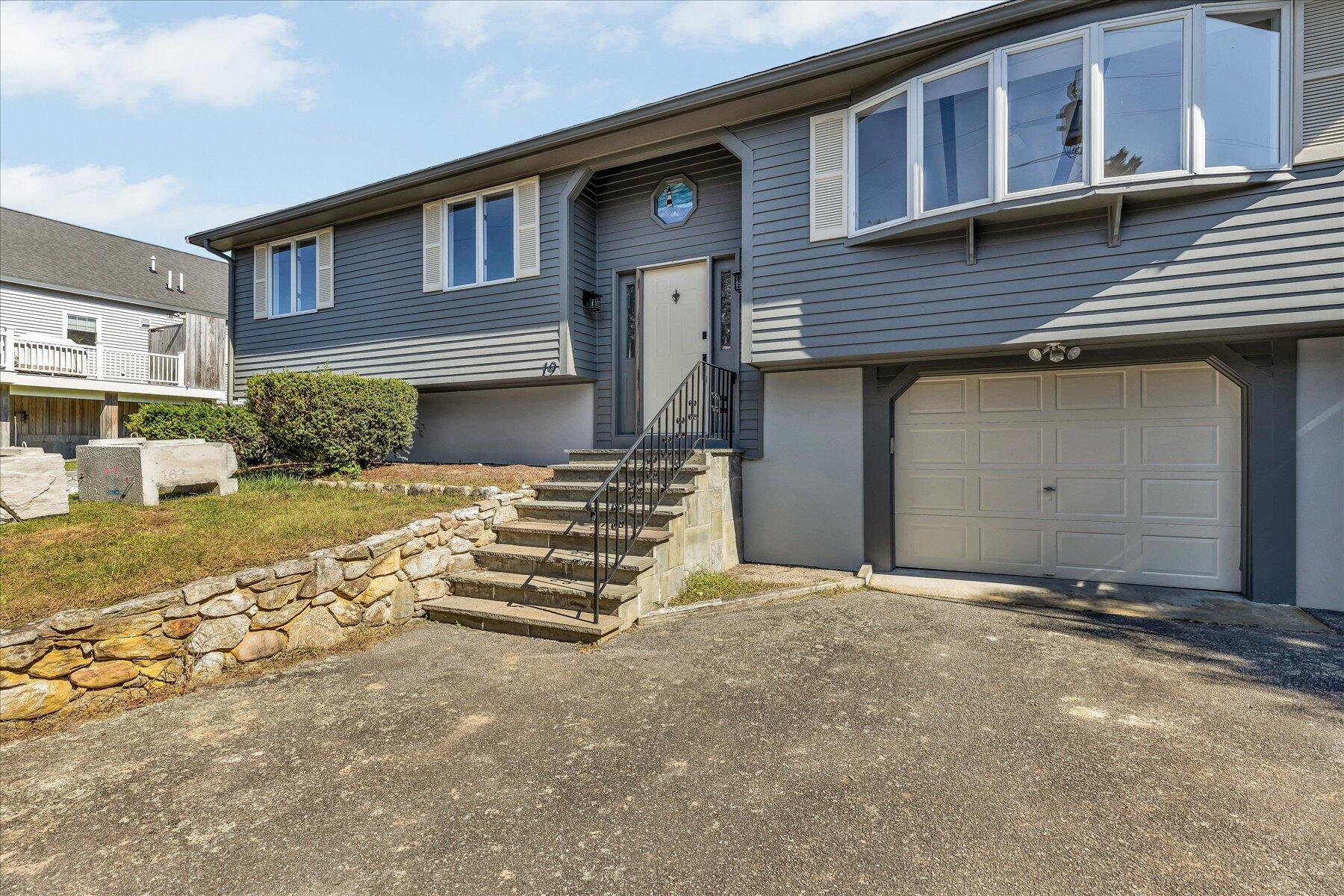 19 Mashnee Road Bourne, MA 02532 - Photo 4 of 46 a front view of a house with a garage