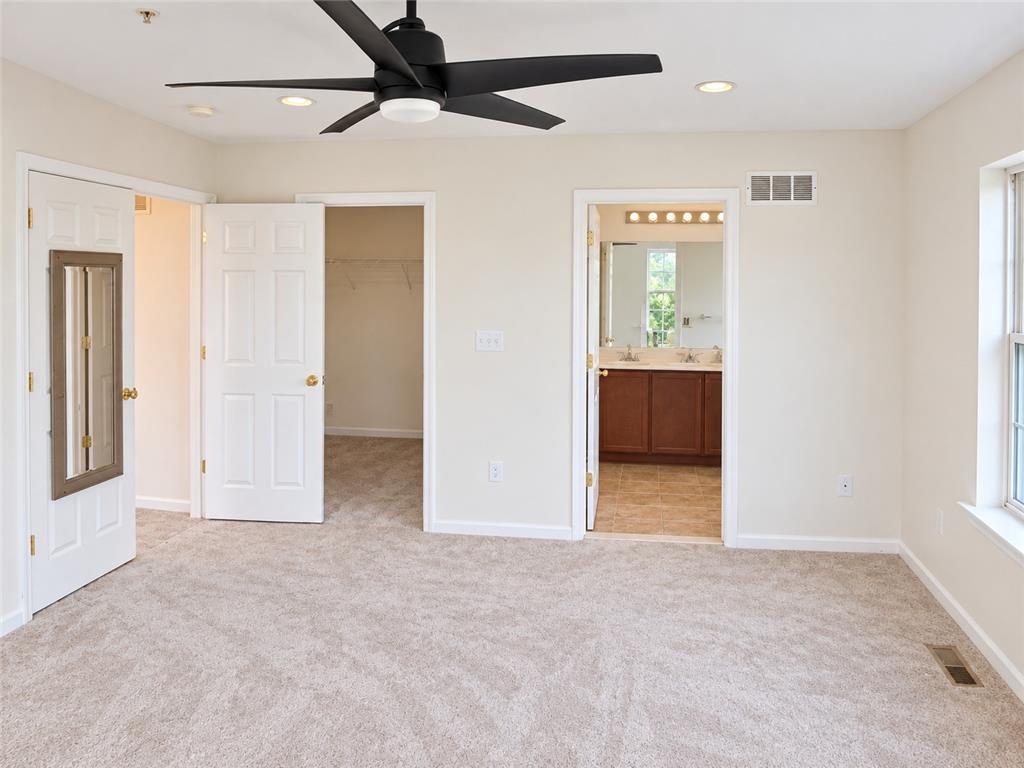 5439 Spring Ridge Drive West Macungie, PA 18062 - Photo 9 of 17 Soft carpeting anchors a versatile bedroom connecting directly to a private bathroom and closet.