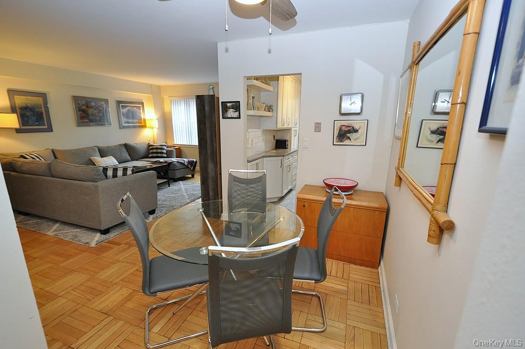 235 Garth Road, Unit A5B Scarsdale, NY 10583 - Photo 16 of 47 a living room with furniture and a flat screen tv