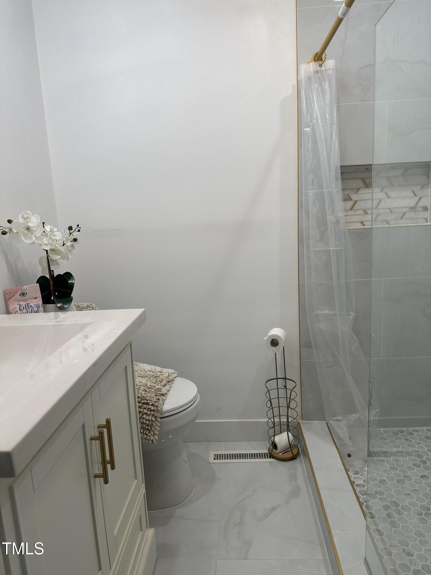 1216 Elizabeth Road West Wilson, NC 27893 - Photo 12 of 34 a bathroom with a sink a toilet and shower