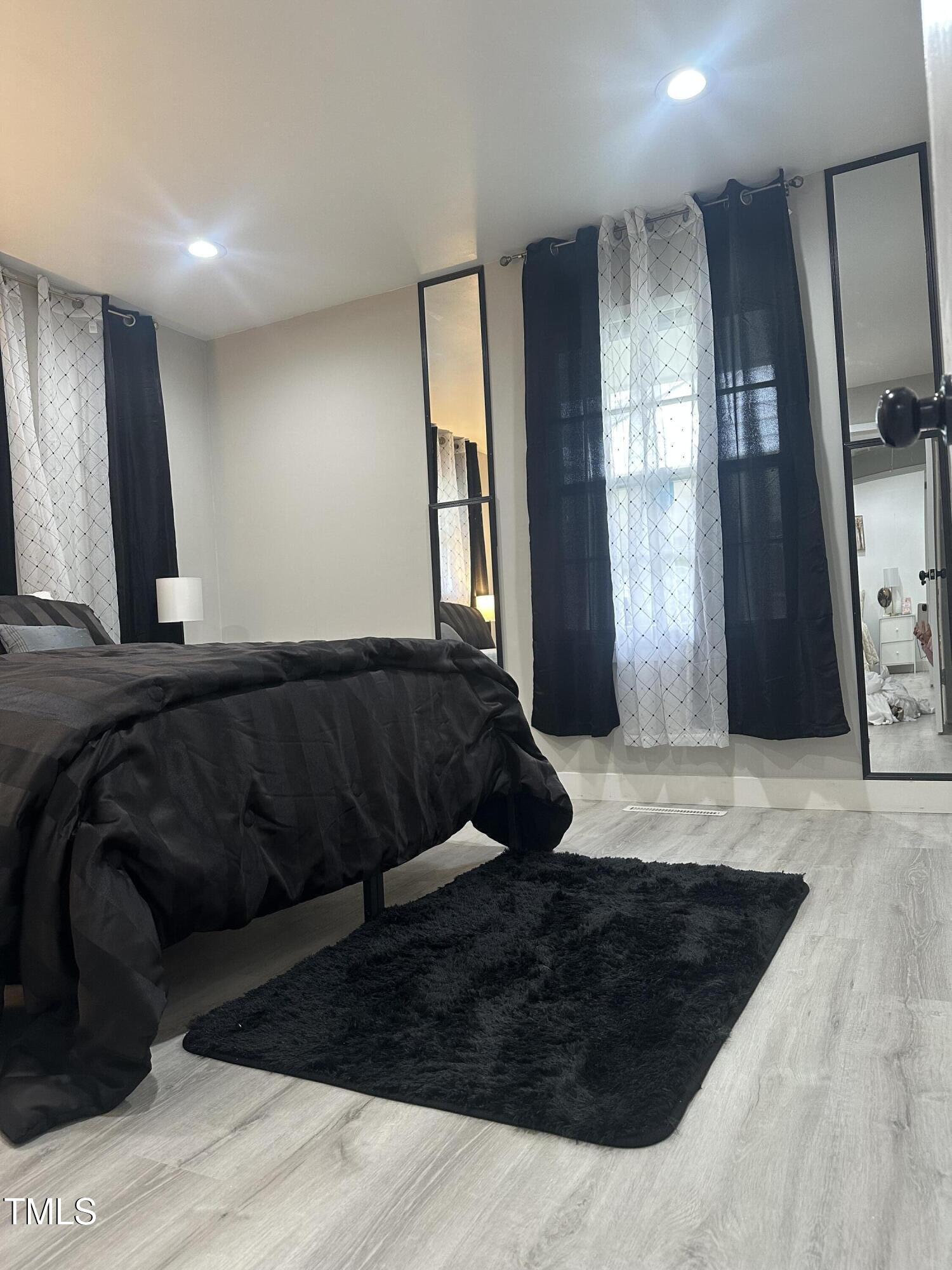 1216 Elizabeth Road West Wilson, NC 27893 - Photo 17 of 34 a bedroom with a bed window and mirror