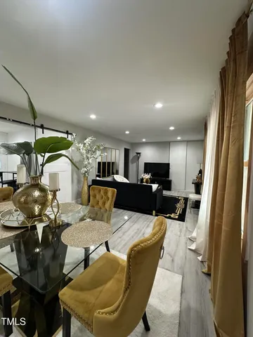 a living room with furniture and a chandelier