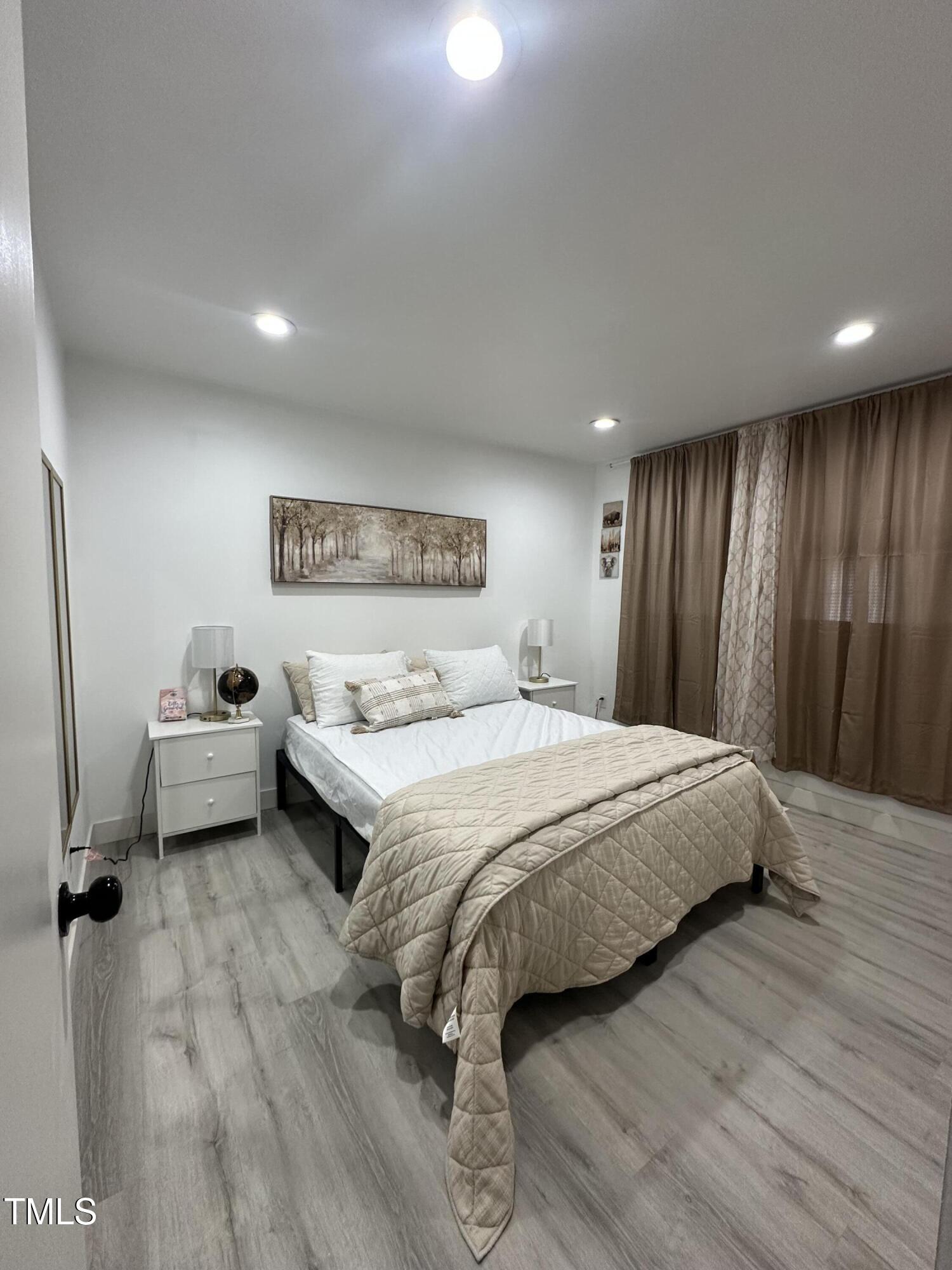 1216 Elizabeth Road West Wilson, NC 27893 - Photo 22 of 34 a spacious bedroom with a bed and a large mirror