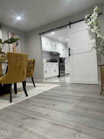 a kitchen with a table chairs refrigerator and microwave