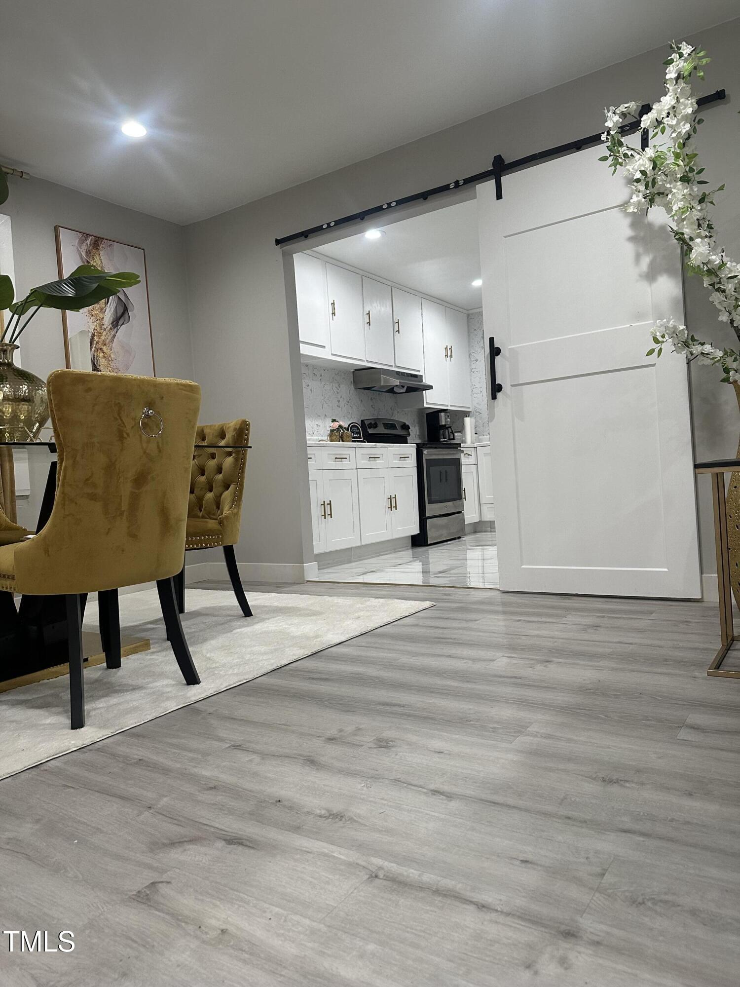 1216 Elizabeth Road West Wilson, NC 27893 - Photo 27 of 34 a kitchen with a table chairs refrigerator and microwave