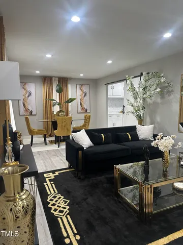 a living room with furniture and a rug