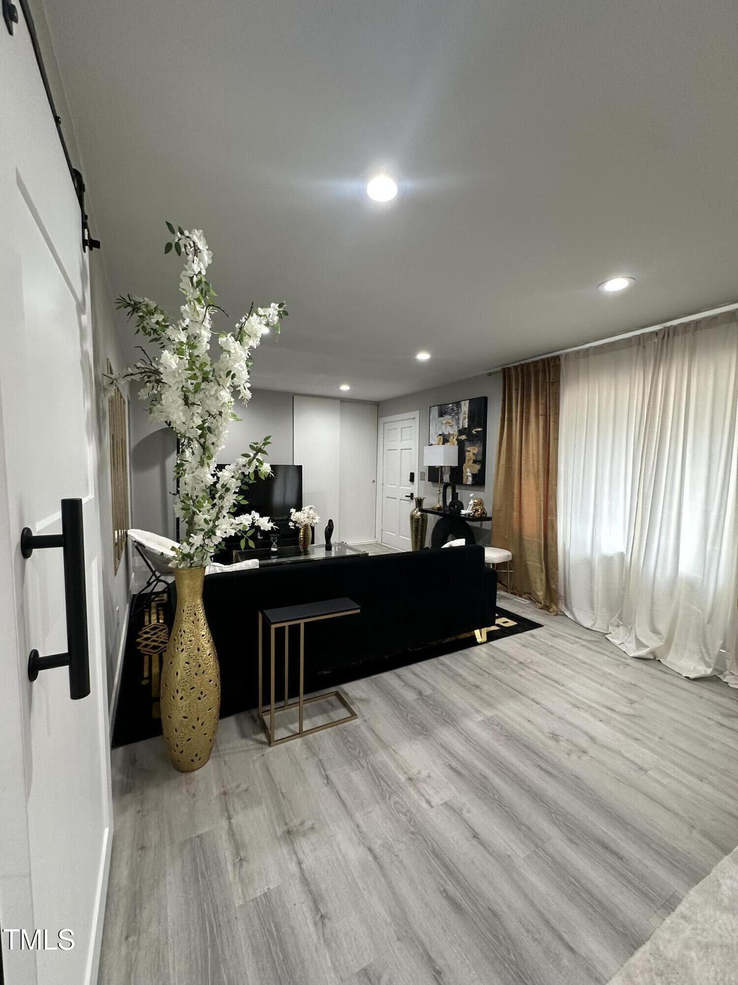1216 Elizabeth Road West Wilson, NC 27893 - Photo 4 of 34 a living room with furniture a chandelier and a fireplace