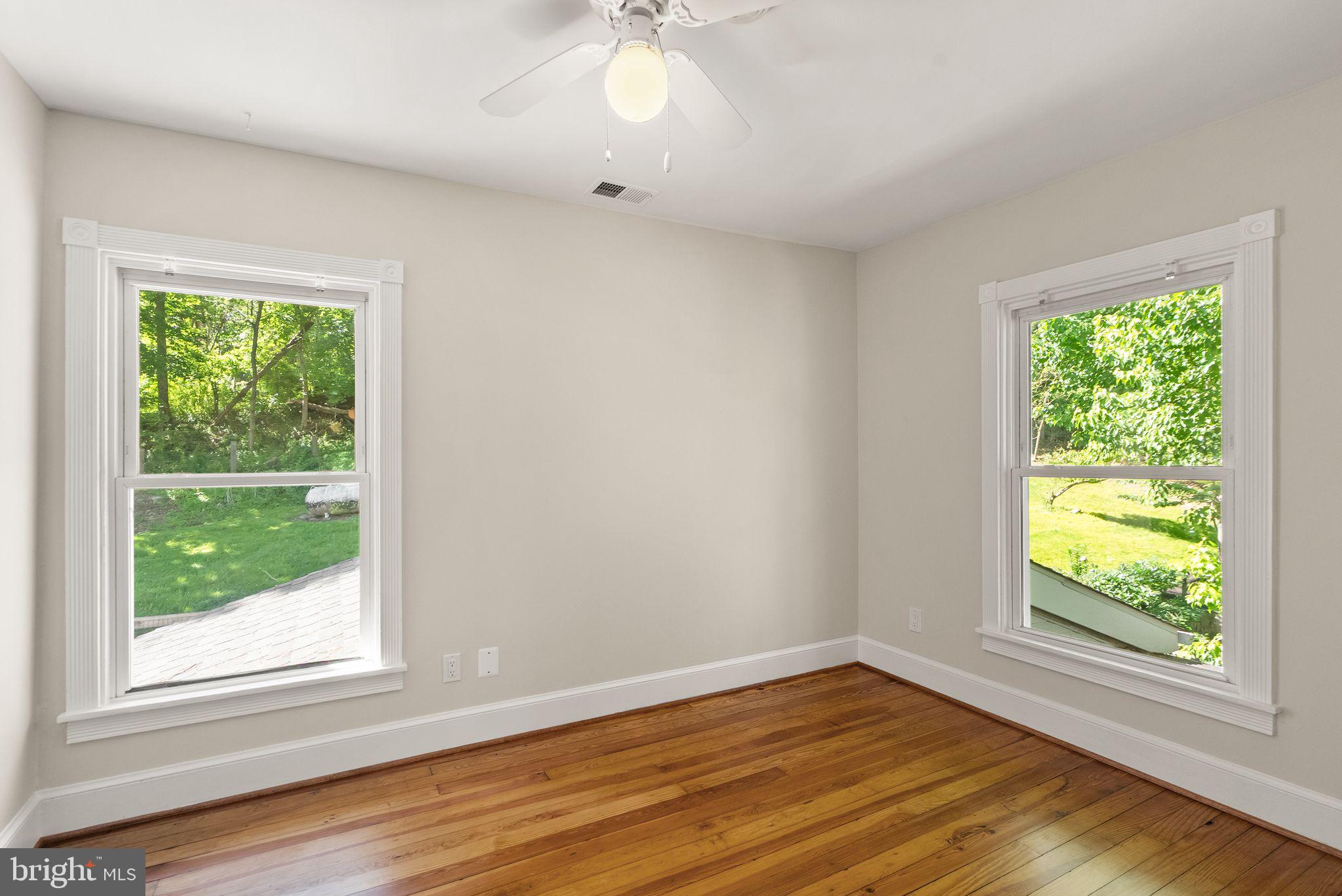 37151 Branchriver Road Purcellville, VA 20132 - Photo 38 of 63 a view of an empty room with wooden floor and a window